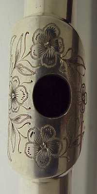 Oval embouchure with floral engraving